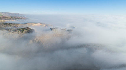 Aerial view of the buildings in fog