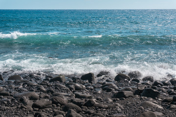 Fototapeta na wymiar HAWAII, USA: black sand beach in Big Island.