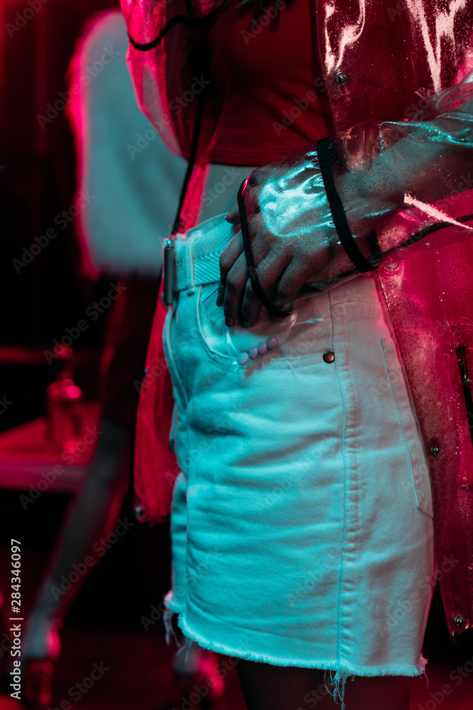 Wall mural cropped view of girl holding plastic zipper bag with drugs in nightclub