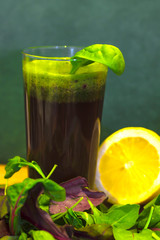 Glass of fresh, homemade, healthy juice from beet leaves, spinach and wild rocket
