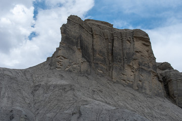 Low angle view of dark grey barren rock formation near Hanksville, Utah