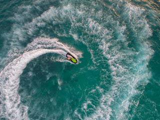 People are playing a jet ski in the sea.Aerial view. Top view.amazing nature background.The color...