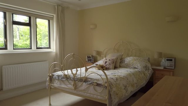 Right to Left Pan of a Modern Looking Bedroom in a Rural Home in Slow Motion