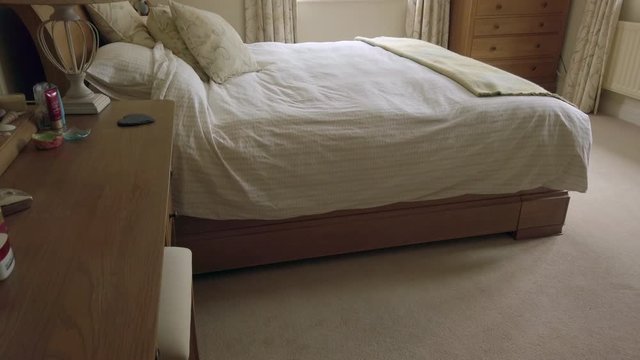 Upward Tilt Shot of a Master Bedroom in a Family Home in Slow Motion