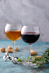 Glasses of white and red wine. The concept of winemaking. Place under your text. Still life on a textural background.