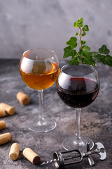 Glasses of white and red wine. The concept of winemaking. Place under your text. Still life on a textural background.