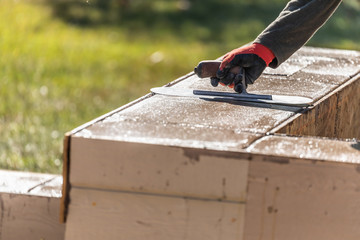 Construction Worker Using Trowel On Wet Cement Forming Coping Around New Pool