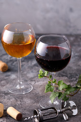 Glasses of white and red wine. The concept of winemaking. Place under your text. Still life on a textural background.