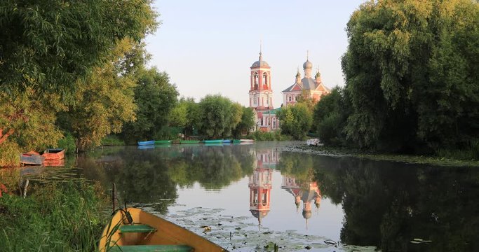 Red church reflecting in Trubezh river in Pereslavl-Zalessky