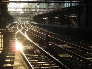 Fototapeta premium Golden sunlight reflecting off the train track at Flinders Street Station
