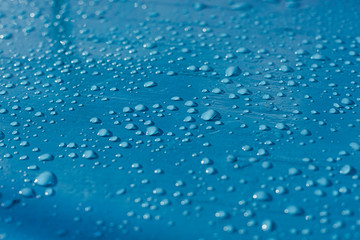 Water drops after rain on the surface of a fishing boat