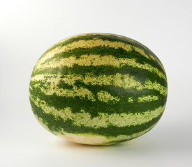 big green striped whole watermelon on a white background