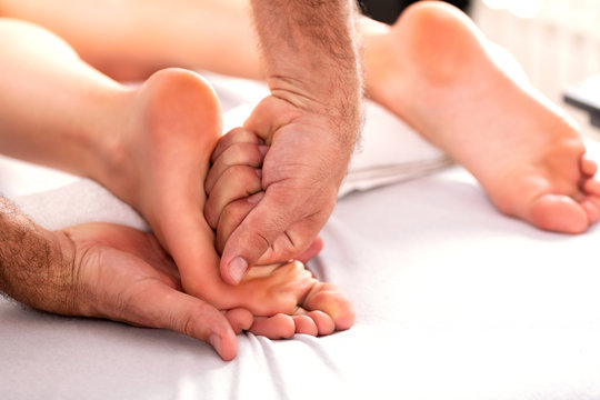 Massaging a foot with a fist