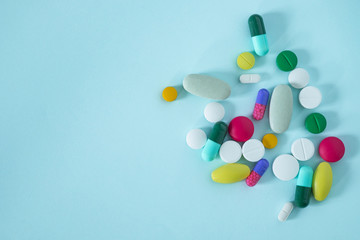 Flat Lay, Top View of Colorful, Assorted pharmaceutical medicine pills isolated on blue background with copy space. . medicine concept