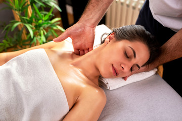 Obraz na płótnie Canvas Masseur applying neck massage therapy