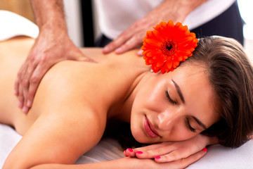 Fototapeta na wymiar Upper back beauty massage in massage salon