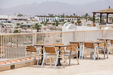 Fototapeta premium Table and chairs in beach cafe next to the red sea in Sharm el Sheikh, Egypt