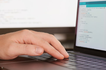 Man typing programming code