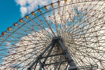 Colorful ferris wheel against clear blue sky in Osaka, Japan
