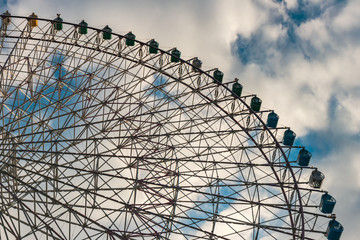 Colorful ferris wheel against clear blue sky in Osaka, Japan