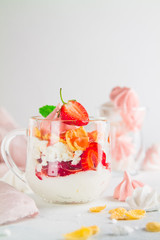 Yogurt dessert in glass glasses with strawberries on a white background