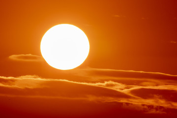 Large Sun on Orange Clouds at Sunset