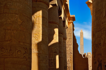 One of two Obelisks of Queen Hatshepsut viewed between columns of the Hypostyle Hall, Temple of Karnak located at modern day Luxor, or ancient Thebes, Egypt