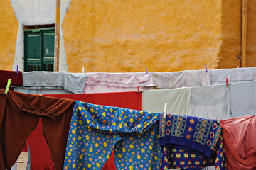 Clothes hanging on line in colorful alley, rural village outside of Luxor, Egypt.