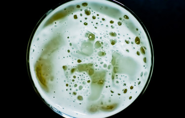 Beer foam and ice on black background