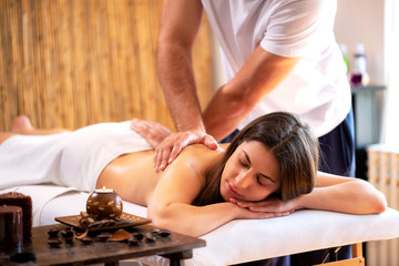 Obraz na płótnie Canvas Young woman enjoying her massage