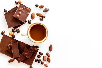 Different variety of chocolate and hazelnut on white background top view space for text