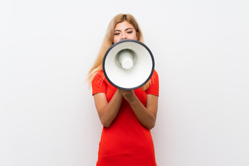 Teenager girl over isolated white background shouting through a megaphone