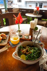 Board with tasty vegetarian pasta on wooden table