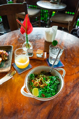 Board with tasty vegetarian pasta on wooden table