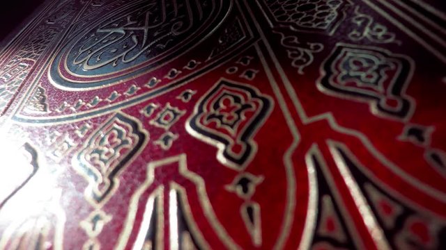Islam. Religion. Quran on a dark background, close-up.