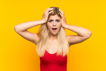 Teenager girl over isolated yellow background with surprise facial expression