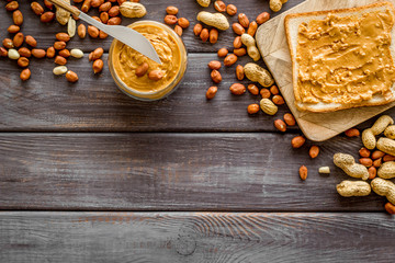 peanut butter for cooking breakfast with sandwiches at home on wooden background top view mock-up