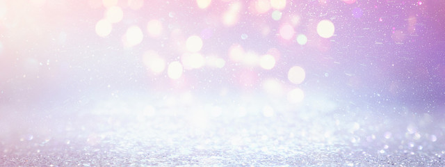 background of abstract glitter lights. purple, pink, gold and silver. de focused. banner