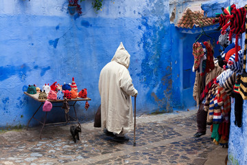 Man wearing a djellaba on the street, Chefchaouen, Morocco