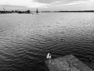Lonely woman alone - Beautiful aerial Riga port and river Daugava lanscape shots from drone - Top view from above
