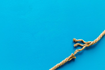 risk concept with rope near to break on blue background top view space for text