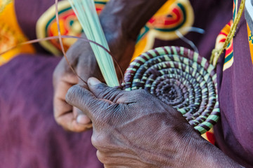 Mbukushu tribe woman weaving grass cushion, Kwando Traditional Village, Zambezi Region, Namibia