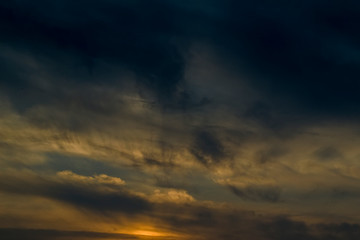 The sky at sunset. Cumulus clouds lit by the rays of the setting sun.