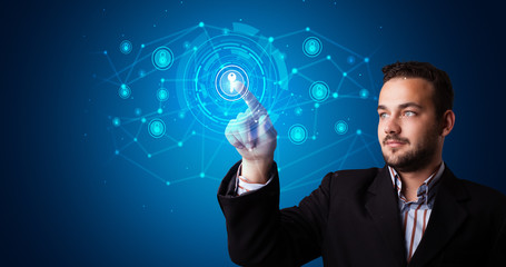 Man touching hologram screen displaying keys and locks