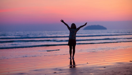 Fototapeta premium Child playing on ocean beach. Kid at sunset sea.