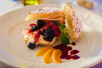 Fruit and pastry dessert on a white plate.