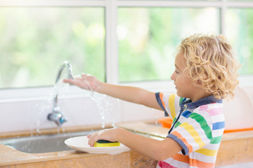 Child washing dishes.
