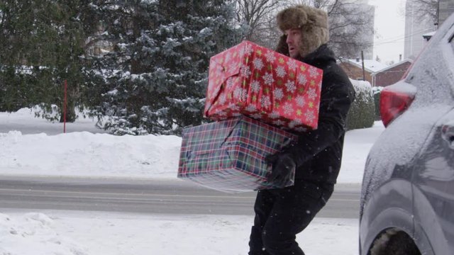 Man slips on ice carrying Christmas gifts