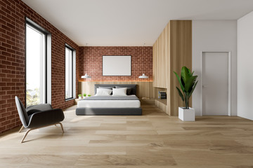 Brick and wooden bedroom interior with armchair