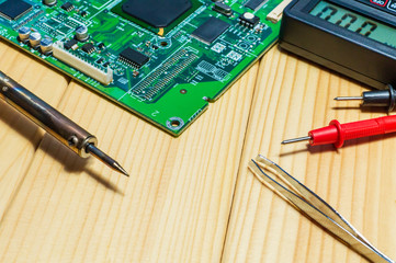 Services for the production of electronics and repair on a wooden background.